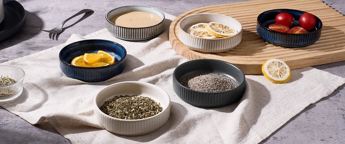 Small ceramic serving bowls arranged with snacks on a table