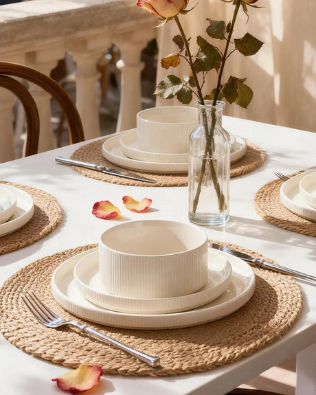 A relaxed everyday table setting with white ceramic plates, bowls, and a simple centerpiece.