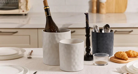 Two ceramic utensil holders organizing tools on a table