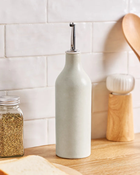 White ceramic Famiware oil dispenser on a kitchen counter