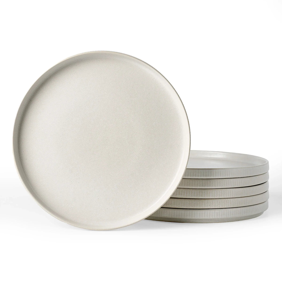 Stacked white ceramic dinner plates on a clean background