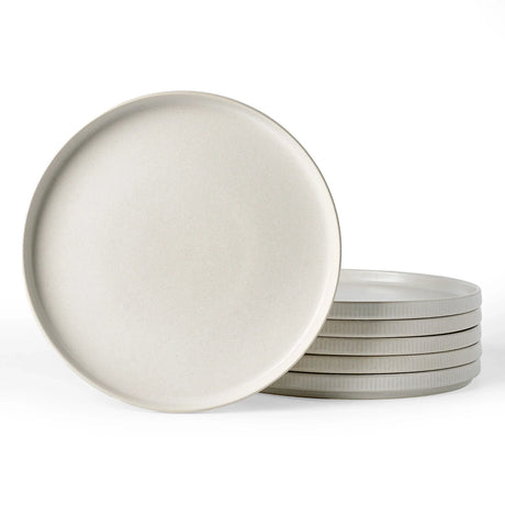 Stacked white ceramic dinner plates on a clean background