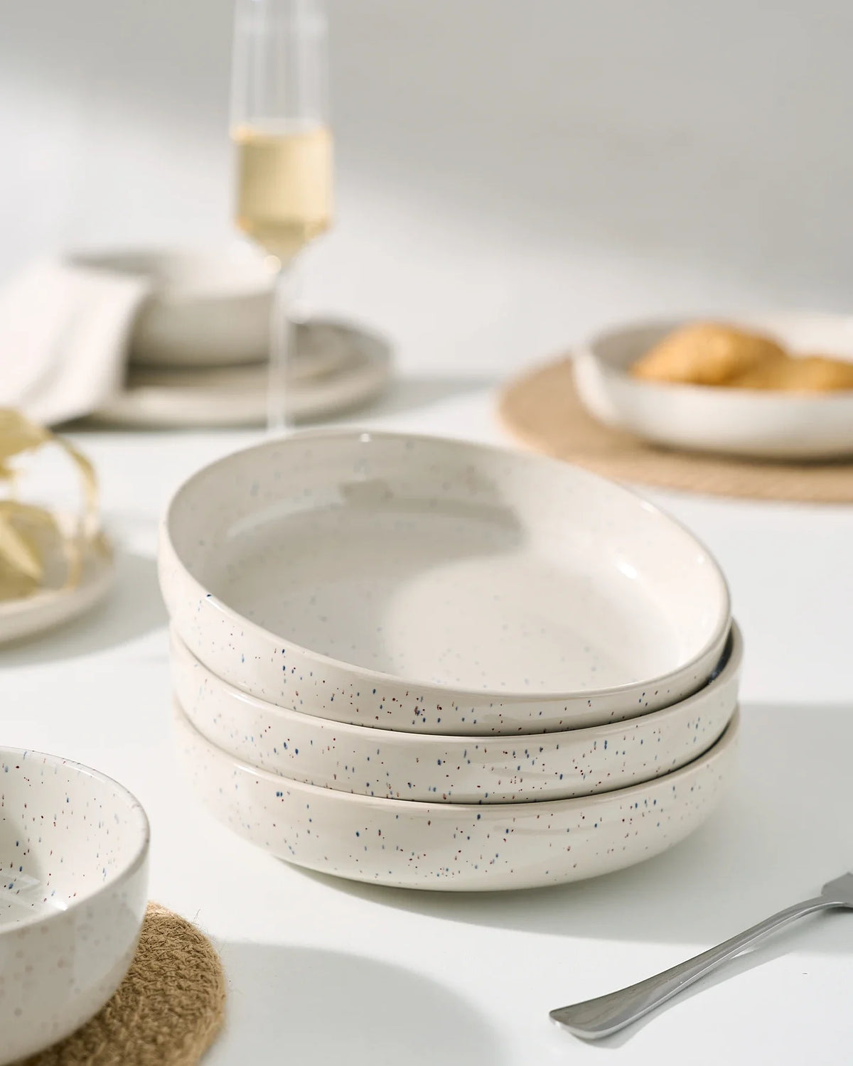 Speckled cream Famiware bowls stacked neatly for display