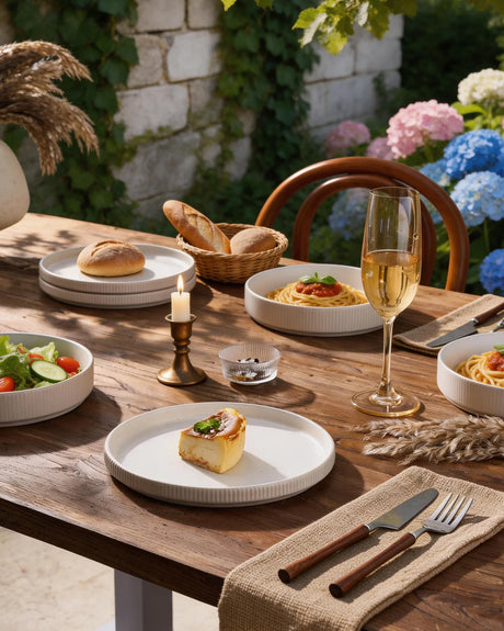 Casual outdoor table with white dinnerware and a low candle