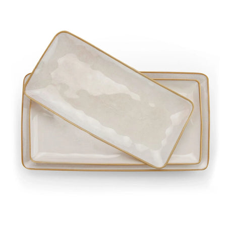 Rectangular cream-colored serving platters with softly rippled surfaces and darker rims