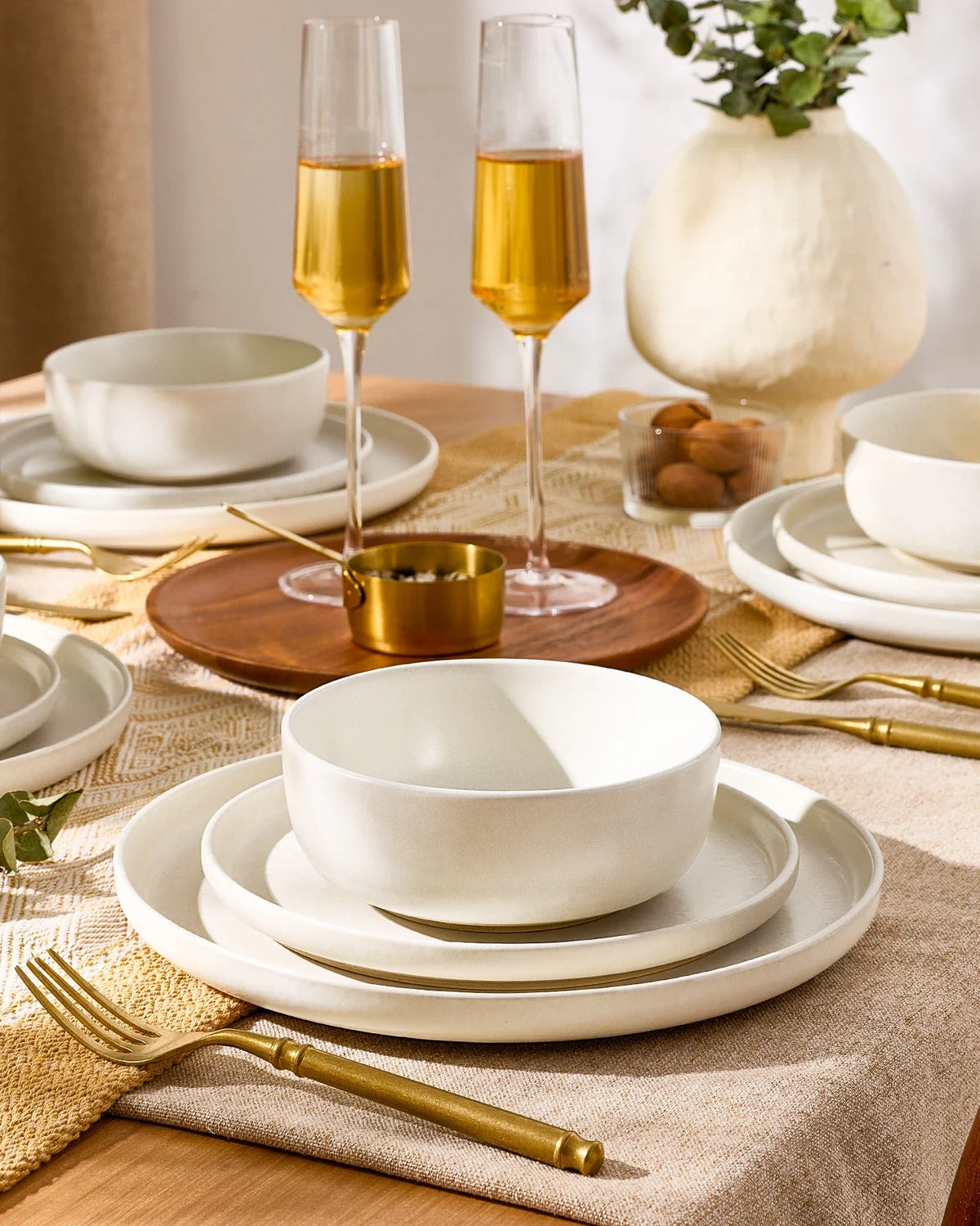 Neutral Famiware stoneware dinnerware set on a warm dining table