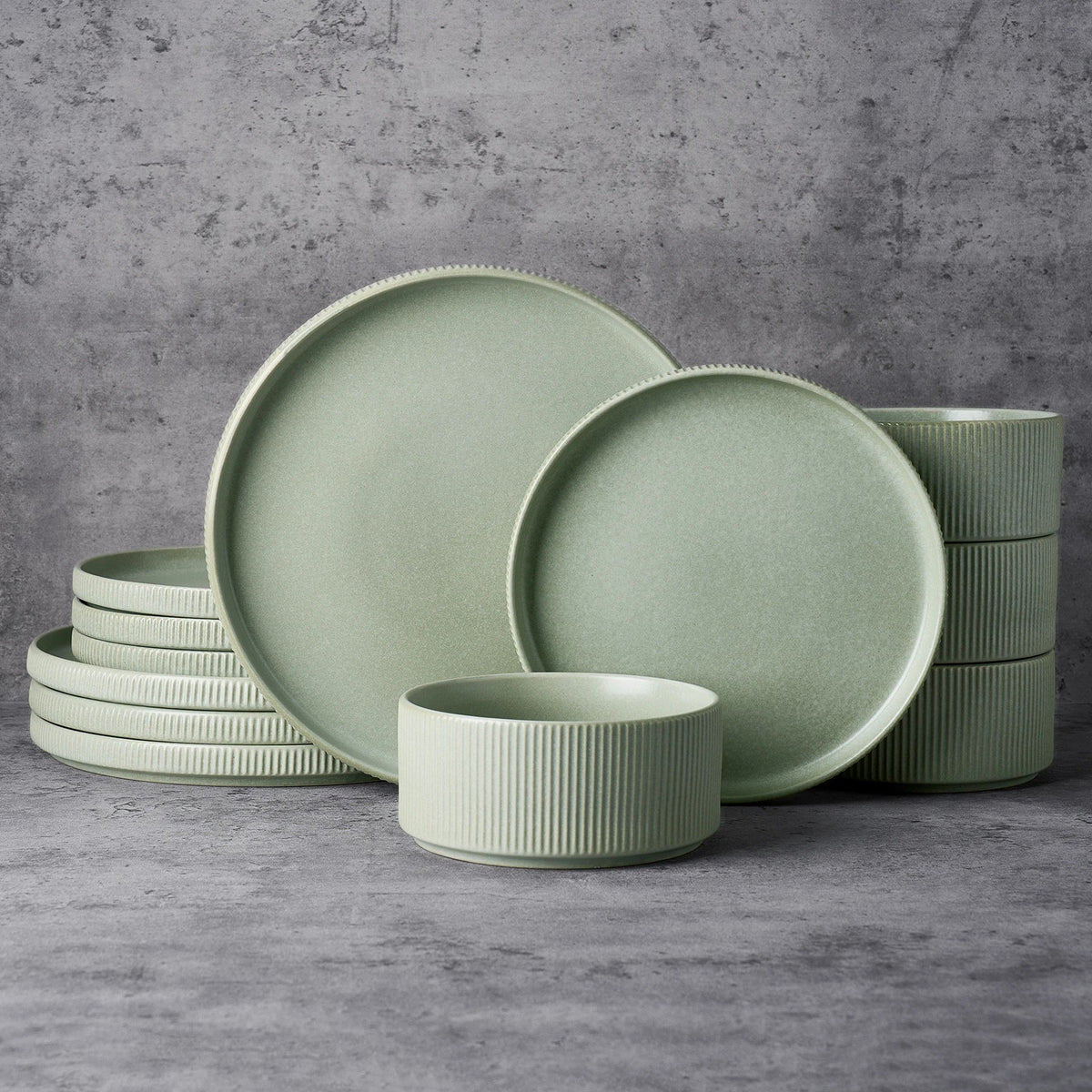 Green ceramic dinner plates, small plates and bowls shown together