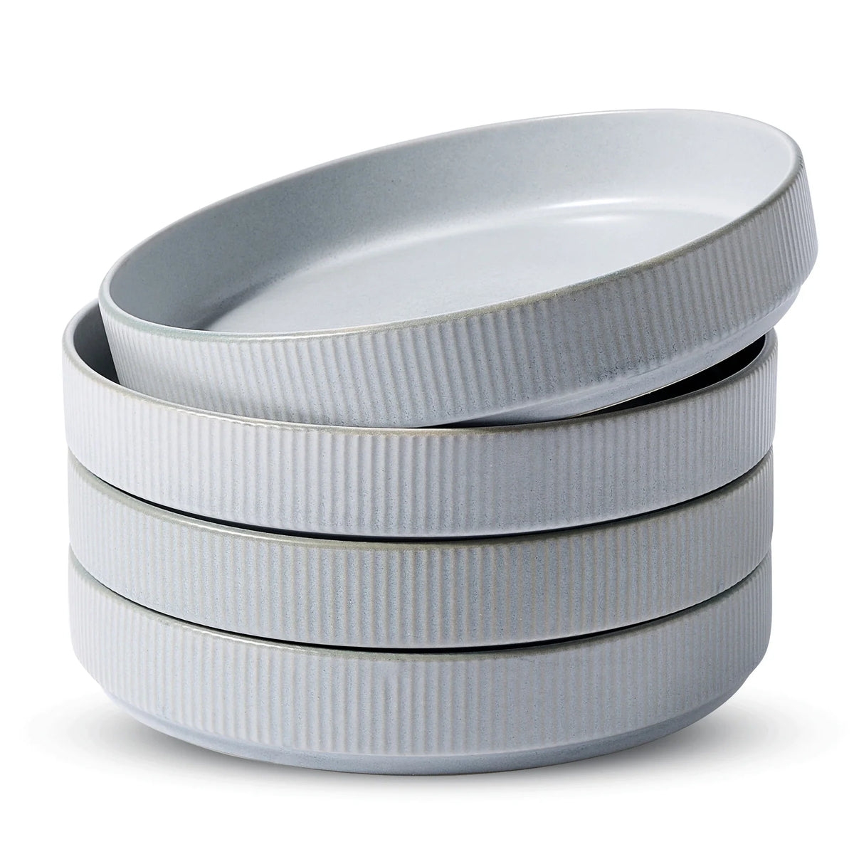 Uncovered gray ribbed ceramic bowls stacked on a white background