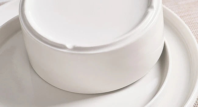Close-up of a raised foot ring on the underside of a white ceramic bowl