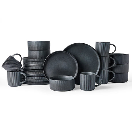 A coordinated dark stoneware dinnerware collection arranged together on a white background.