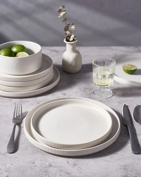 White Famiware plates beside stainless-steel flatware