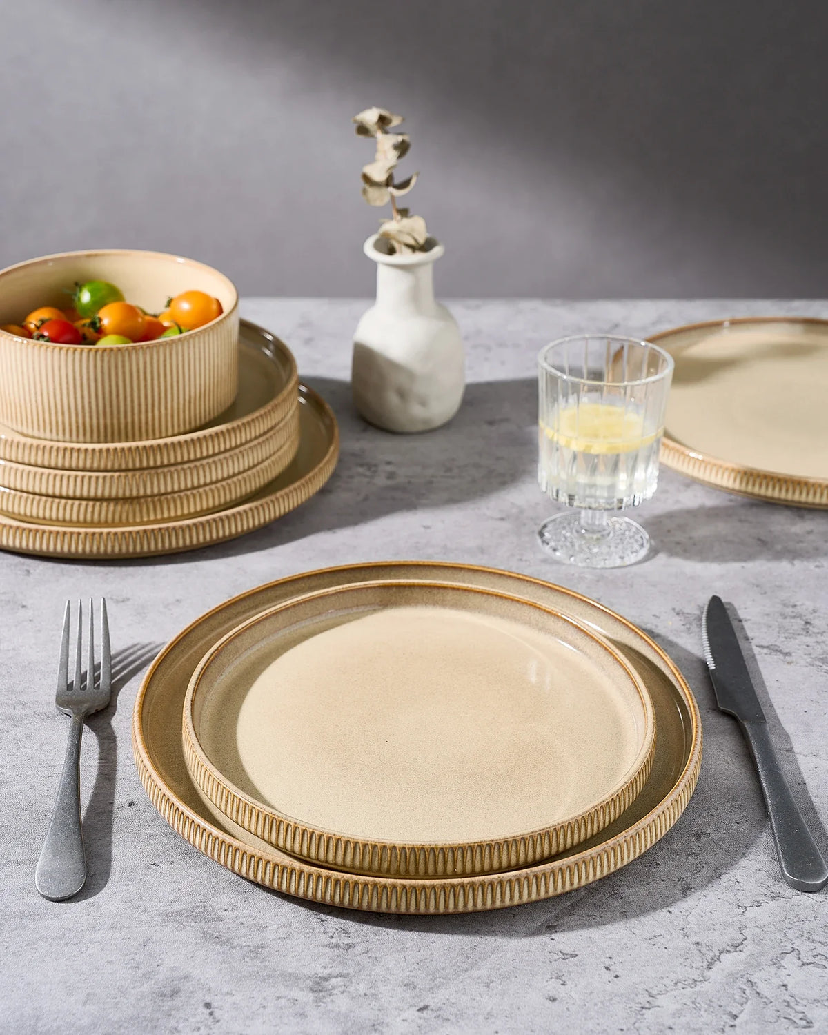 Oatmeal-colored Famiware plates arranged for an everyday place setting